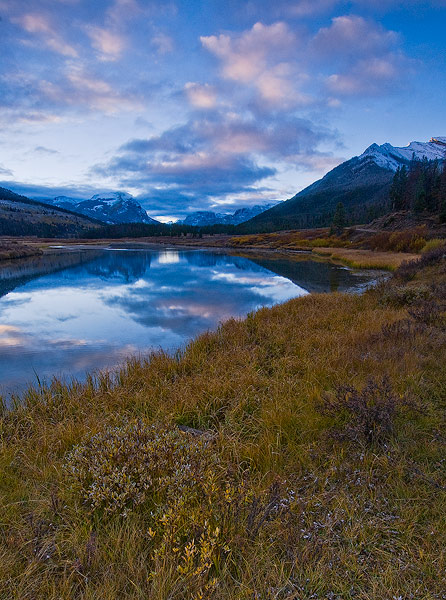 Snow covered peaks of the Wind River Range reflect in the Green River at sunrise on an Autumn morning